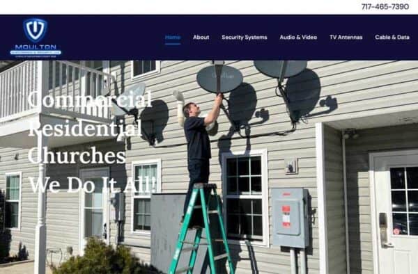 A technician stands on a green ladder installing a satellite dish on the exterior wall of a light gray building. Text on the image reads: Commercial, Residential, Churches, We Do It All!—perfect for your website portfolio.